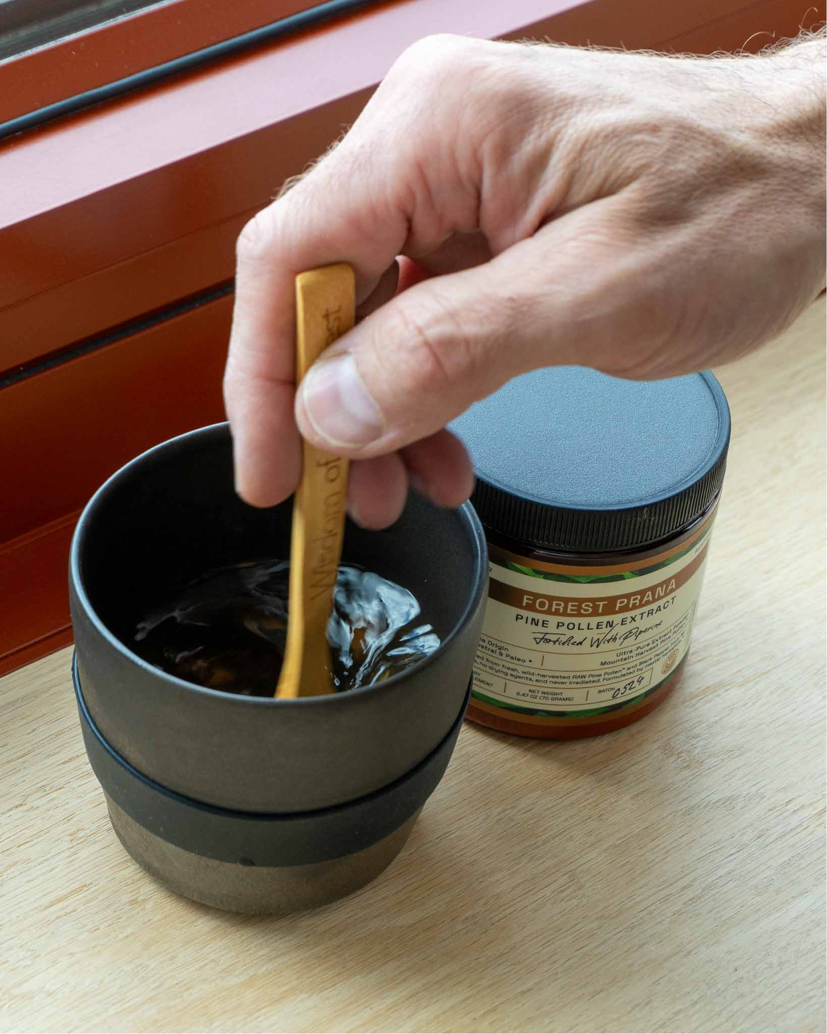 Stirring Pine Pollen Extract Powder into hot water until dissolved
