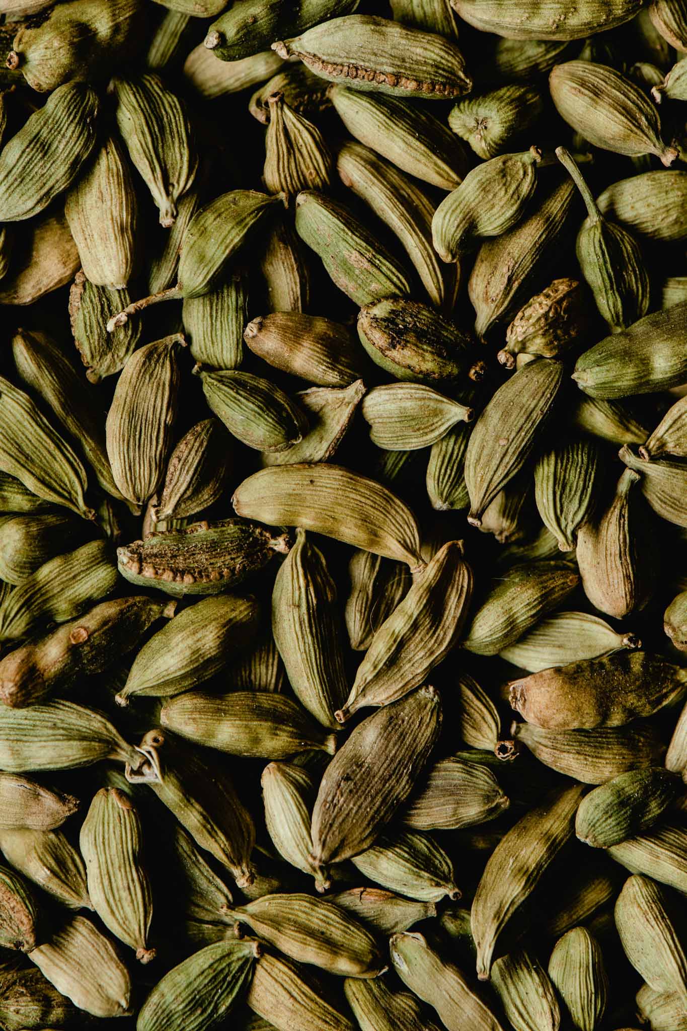 Close-up of green cardamom pods, showcasing their texture and color.