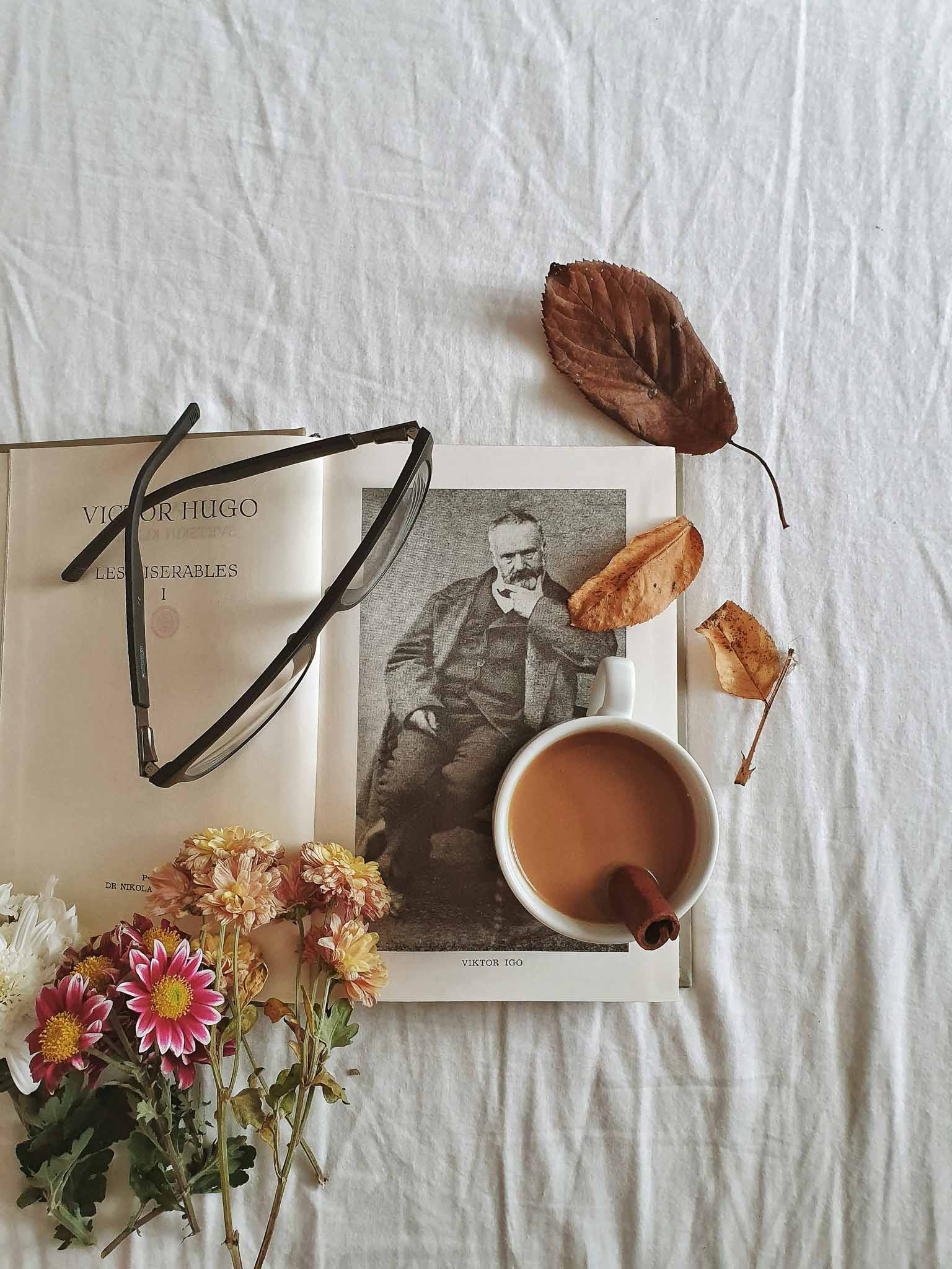 Cozy winter morning scene with a cup of coffee and knitting materials on a bed.